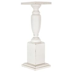 a white pedestal with a lamp on top