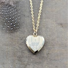 "This vintage locket is engraved with a double heart design on the front; the reverse is plain. The 12k gold filled heart opens revealing two frames in which to place your favorite photos. The locket hangs from a new 14k gold filled cable chain finished tiny gold balls at the lobster clasp closure. Locket 24x20mm Necklace length 18\" (45cm) ✦All of our vintage lockets ship with complimentary insurance✦ ✤Our entire selection of lockets can be found here✤ http://www.etsy.com/shop/LexiandGem?sectio Traditional Heart-shaped Jewelry For Weddings, Traditional Heart Jewelry For Wedding, Traditional Heart-shaped Wedding Jewelry, Heirloom Etched Jewelry For Wedding, Heirloom Etched Wedding Jewelry, Victorian Jewelry With Heart Charm For Anniversary, Heirloom Engraved Locket Necklace For Valentine's Day, Heirloom Engraved Jewelry For Valentine's Day, Vintage Heart Charm Locket Necklace For Wedding