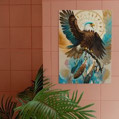 an eagle painting hangs on the wall next to a potted plant