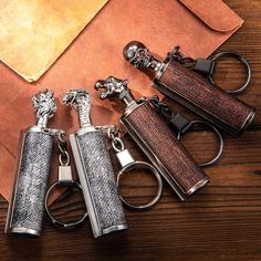 four different types of lighters sitting on top of a wooden table next to an envelope