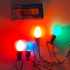 some lights that are sitting on the ground in front of a box with an electrical cord attached to them