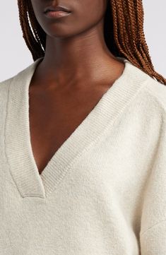 An oversized fit feels so right and relaxed in this V-neck sweater knit from cotton-blend yarn. V-neck Long sleeves Dropped shoulders Ribbed cuffs and hem 56% cotton, 19% acrylic, 18% polyester, 5% nylon, 2% spandex Hand wash, dry flat Imported Oversized Cream V-neck Sweater, Oversized Neutral V-neck Sweater, Oversized V-neck Sweater For Loungewear, V-neck Sweater For Loungewear, Neutral V-neck Sweater For Winter, Neutral V-neck Winter Sweater, Cream Chunky Knit V-neck Sweater, Cream V-neck Chunky Knit Sweater, Cream Soft Knit V-neck Sweater