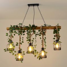 a bunch of light bulbs hanging from a wooden beam with ivy growing on them and some lights attached to the ceiling