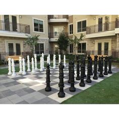 a giant chess set in front of an apartment building