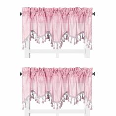 two pink curtains with tassels hanging from the top and bottom of each curtain