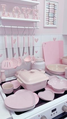 a stove top oven sitting inside of a kitchen filled with dishes and utensils