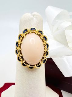 Beautiful 14K Yellow Gold Pink Coral & Blue Enamel Vintage Ring size 4.75 A perfect gift for your loved one for any special occasion or holiday! Total Ring Weight: 6.32g Ring Length: 27.05mm Ring Width: 17.88mm Gemstone: Pink Coral, Blue Enamel Item will be placed into a gift box. * Luxury Oval Enamel Ring For Gifts, Luxury Oval Cabochon Sapphire Ring As Gift, Cabochon Sapphire Ring Fine Jewelry Gift, Cabochon Sapphire Ring Gift, Elegant Blue Oval Enamel Ring, Heirloom Style Formal Enamel Ring, Luxury Cabochon Sapphire Ring Gift, Oval Gemstone Enamel Ring As Gift, Oval Enamel Gemstone Ring As Gift