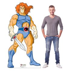 a man standing next to a cardboard cutout of he - man