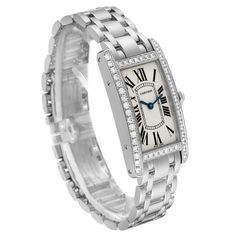 Cartier Tank Americaine White Gold Diamond Ladies Watch WB7073L1. Quartz movement. 18K white gold case 19.0 x 35.0 mm. Octagonal crown set with original Cartier factory faceted diamond. . Scratch resistant sapphire crystal. Silvered grained dial with black Roman numeral hour markers and an inner minute track. Sword-shaped blued steel hands. 18K white gold bracelet with hidden butterfly clasp. Fits a 6" wrist. Cartier Diamond Watch With Round Dial, Cartier Diamond Watch With Diamond Accents, Classic Platinum Diamond Watch With Brilliant Cut, Luxury Cartier Diamond Watch With Diamond Accents, Luxury Cartier Diamond Watch For Anniversary, Classic Diamond White Watch With Brilliant Cut, Classic Wedding Jewelry And Watches With Diamond Hour Markers, Cartier Diamond Watch With Brilliant Cut, Cartier Diamond Watch With Polished Finish For Formal Occasions