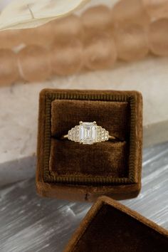 an engagement ring sitting in a velvet box