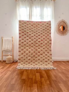 a room with wood floors and a rug on the floor