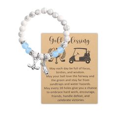 a white beaded bracelet with an airplane and golf cart charm on the back of it