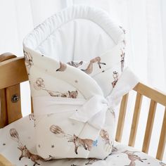 a baby crib with two pillows on top of it and a pillow in the middle