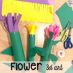 some paper flowers sitting on top of a wooden table