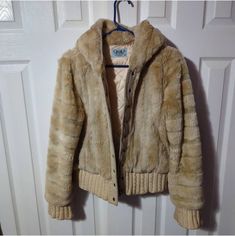 Juicy Couture Vintage Faux Fur Jacket. XL Vintage Juicy faux fur jacket in beige/cream and tan. Features zip up & snap closure, two front pockets, hooded, and genuine silk monogram lining. Great condition other than a hole in the wrist cuff. See photos:). i know it looks dirty looking in the photos but i swear its clean and more beautiful in person! might have to add better pics  Size is XL in womens. Measurements are approximate Length 22" Chest 23" (x2 46") Shoulder to shoulder 17"  Sleeve Len Vintage Faux Fur Outerwear With Long Sleeves, Vintage Faux Fur Long Sleeve Outerwear, Vintage Long Sleeve Faux Fur Outerwear, Beige Fur Coat For Cold Weather, Beige Hooded Fur Coat With Faux Fur Trim, Beige Hooded Fur Coat For Cold Weather, Fitted Beige Outerwear With Faux Fur Lining, Beige Faux Fur Outerwear For Cold Weather, Hooded Beige Fur Coat For Winter