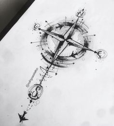 a black and white photo of a compass tattoo on the back of a sheet of paper