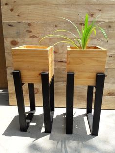 two wooden planters sitting next to each other