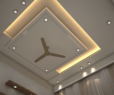 a ceiling fan mounted to the side of a wall in a room with beige walls