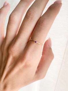 Our February Ring is the perfect gift for anniversary, wedding, bridal proposal, birthday or for a new mama to be! They are great stacking rings as well and look great with any of our other stacking rings. DETAILS: - February birthstone - 14k Gold Fill, 1mm band - Purple CZ stone, 2mm 14K GOLD FILL: Gold fill is a pressure bonded material that has 100% more gold than gold plating. It does not chip, flake or rub off and is tarnish resistant. Anyone who can wear gold can wear gold filled without w Delicate Tiny Jewelry For Anniversary, Delicate Promise Birthstone Ring, Dainty Diamond Promise Ring With Birthstone, Minimalist Birthstone Ring With Round Band For Promise, Solitaire Jewelry For Promise With May Birthstone, Fine Jewelry Wedding Birthstone Ring, Simple Initial Ring As Gift, Delicate Promise Jewelry, Dainty Initial Ring For Promise