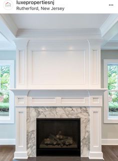 an empty fireplace in a large room with white walls and wood flooring on either side