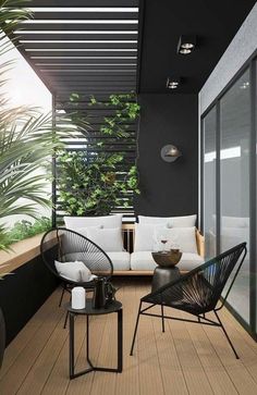 an outdoor living area with black and white furniture, potted plants on the balcony