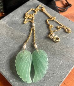 Embrace the soothing energy of our Aventurine Angel Wings Necklace.Meticulously crafted, this exquisite piece of jewelry on a gold filled chain showcases the calming green hues of Aventurine, delicate angel wings and symbolize the potential for growth, prosperity, and emotional healing in your life.  Material: Chain: 14 K Gold Filled Wings: Carved Aventurine Detailing: Fresh water Pearl Aventurine Gemstone Necklace For May Birthstone, Handmade Spiritual 14k Gold Filled Necklace, Gold Chalcedony Jewelry As A Gift, Jade Jewelry With Natural Stones For Anniversary, Spiritual Jade Jewelry For Anniversary, Elegant Amazonite Jewelry For Gifts, Spiritual Aventurine Jewelry For May Birthstone, Jade Necklace For May Birthstone With Spiritual Style, Spiritual 14k Gold Filled Pendant Necklace