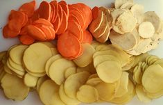 sliced potatoes and carrots on a cutting board with the peels cut into smaller pieces