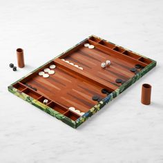 a wooden board game set up on a marble table with two pieces of wood in the middle