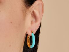 A fun take on the classic hoop. These hoops pair turquoise enamel and brilliant gold into one must-have design. Wear solo or style with refined studs for a sleek finish. 14k gold plated over brass. Hoop dimension: 18mm x 24mm Hypoallergenic, nickel and lead free Tarnish resistant Gold Filled Jewelry, Jewelry Pouch, Jewelry Gift Box, Jewelry Plate, Pure Silver, Free Jewelry, Sterling Silver Jewelry, Solid Gold, Jewelry Gifts