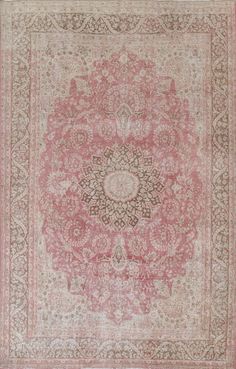 an antique rug with pink and brown colors