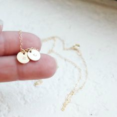 "Tiny Gold Initial Necklace This delicate little initial is hand stamped on a tiny gold filled charm {8mm}. It is customized for you with an initial of your choice. It adorns a 14kt gold filled shimmering link chain. Select up to 4 charms for your necklace! D E T A I L S -Choose from 1-4 tiny discs -Disc measures 8mm - 14kt Gold-Filled discs and necklace -A high quality delicate link chain with a spring clasp. -Polished to a light satin finish. CUSTOM HAND STAMPING -Hand stamped with an initial. Dainty 14k Gold Filled Hand Stamped Necklace, Minimalist 14k Gold Hand Stamped Charm Necklace, Dainty Hand Stamped 14k Gold Charm Necklaces, Minimalist Yellow Gold Hand Stamped Charm Necklace, Dainty Hand Stamped Initial Necklace For Gift, Dainty Hand Stamped Initial Necklace As Gift, Dainty Hand Stamped Round Charm Necklace, Dainty Round Hand-stamped Charm Necklace, Dainty Hand-stamped Round Charm Necklace