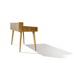 a small wooden table sitting on top of a white floor next to a chair in front of it