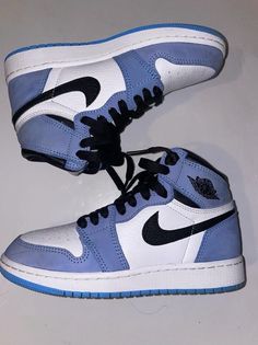 Elevate your sneaker game with these stylish Air Jordan 1 Retro OG High University Blue sneakers. The shoe features a high top design, crafted with a white, university blue, and black colorway, and the iconic Jordan logo on the side. These sneakers are perfect for any athletic occasion and will surely turn heads with their sleek design. The size 3.5 sneakers are made for men and are part of the Air Jordan product line. They were released in 2021 and are a must-have for any sneaker enthusiast. Don't miss out on the opportunity to add these University Blue sneakers to your collection. Dream Shoe Collection, Nike Air Jordans Blue, Nikes For Men, Nikes For Women, Air Jordans Men, Blue Wishlist, White And Blue Shoes, High Top Nikes, Jordan Boots