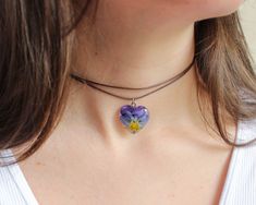 Violet flowers have the ability to hear other people's thoughts. This flower necklace choker, part of my pansy jewelry, has a beautiful story behind. Do you want to hear it? Miguel was a shy boy who had no friends. His only friend was a pansy flower that grew in a corner of his village. When Miguel talked to her, she listened to his words and thoughts, and little by little that beautiful flower gave Miguel love and self-esteem to fill him with happiness and friends 🌸 This flower necklace choker Adjustable Flower Clavicle Chain Jewelry, Adjustable Flower Charm Choker, Adjustable Clavicle Chain Jewelry With Flower Shape, Flower Charm Choker As A Gift, Flower Choker Necklace As Gift, Flower Choker Necklace With Clavicle Chain For Gift, Flower Choker Necklace With Clavicle Chain As A Gift, Flower Shaped Choker With Flower Charm As Gift, Floral Choker With Flower Charm As A Gift