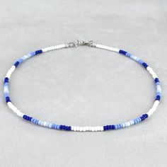 Dainty seed bead necklace featuring blue and white glass seed beads. Beautiful hues of light and dark blues and white combination creates a soothing beaded blue necklace which can be secured by a sturdy lead and nickel free brass lobster clasp. Lightweight, comfortable and suitable for all day wear, this blue choker necklace has a comfortable choker fit. Measurements(approx, see 3rd photo) Necklace Length:16"(including clasp) Beads:3 mm You may also like the below blue beaded choker necklace htt Necklaces Seed Beads, Blue Beaded Necklace Ideas, Necklace With Beads Ideas, Cute Necklace Ideas Beads, Ideas For Beaded Necklaces, Seed Beads Necklace Ideas, Seed Bead Accessories, Beaded Necklaces Ideas, Diy Seed Bead Necklace