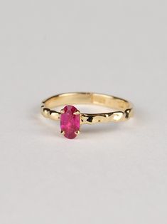 This oval ruby ring is truly exceptional, combining refined design with minimalist charm. It is a timeless piece that is both classically elegant and strikingly modern. The warm tone of the gold beautifully complements the deep red-pink hue of the ruby, creating a stunning contrast that captures attention. The centerpiece of this ring is a gorgeous 0.6-carat ruby sourced from Tanzania. The fluid design of the band reflects light brilliantly, adding a contemporary touch to this exquisite piece. T Minimalist Oval Ruby Wedding Ring, Modern Oval Ruby Ring For Wedding, Minimalist Oval Ruby Ring For Anniversary, Timeless Oval Yellow Gold Ruby Ring, Minimalist Oval Yellow Gold Ruby Ring, Oval Ruby Ring In Yellow Gold Timeless Style, Minimalist Oval Ruby Ring In Yellow Gold, Timeless Oval Ruby Ring In Yellow Gold, Minimalist 14k Gold Oval Ruby Ring