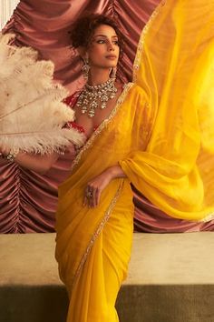 Yellow pre-draped saree embellished by bead-mirrorwork floral vine motif border. Comes with applique floral motif embellished by mirror, bead, sequin blouse and petticoat. - Aza Fashions Designer Wear Draped Dupatta With Mirror Work, Designer Draped Dupatta With Mirror Work, Designer Mirror Work Draped Dupatta, Draped Georgette Traditional Wear With Mirror Work, Eid Mirror Work Draped Dupatta, Bollywood-style Draped Wedding Blouse Piece, Draped Chanderi Saree With Dupatta, Festive Chanderi Draped Dupatta, Draped Blouse With Zari Work For Wedding