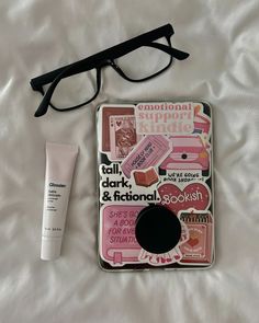 a pair of glasses, eyeglasses and sticker on a bed