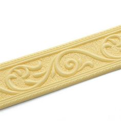 an ornate design is shown on the side of a white wallpaper border that has been painted in yellow