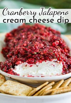 cranberry jalapeno cream cheese dip on a plate with crackers