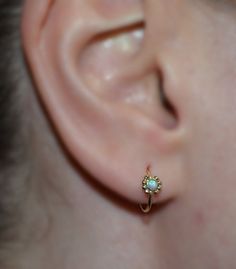 ⋙ 14kt Gold Filled opal tragus ring.⋙ This listing is for one earring.⋙ Available gauges for the ring: 20g; 18g; 16g.⋙ Please note: the less gauge number, the thicker ring is.⋙ Available interior (inner) diameters: 7mm; 8mm; 9mm; 10mm⋙ Available gemstones: ruby; lapis lazuli; black onyx; emerald; light blue opal; garnet; white opal; kiwi green opal; amethyst; aqua blue cz; clear cz; black-red opal; turquoise; blue sapphire⋙ Measurements:⋙ The stone is 2mm in diameter⋙ ⋙ I will put your order int Tiny 14k Gold Huggie Earrings, Dainty Birthstone Huggie Earrings For Anniversary, Halo Huggie Earrings In 14k Gold As A Gift, 14k Gold Huggie Earrings With Halo For Gift, 14k Gold Huggie Earrings With Halo Detail As Gift, Tiny Delicate Hoop Jewelry, 14k Gold Small Hoop Earrings, 14k Gold Halo Huggie Earrings As Gift, Delicate Tiny Hoop Jewelry