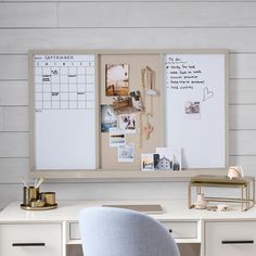 a white desk topped with a chair next to a dry erase board