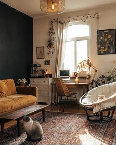 a cat sitting in the middle of a living room with two chairs and a desk