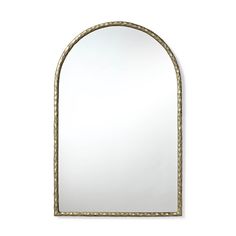 an arch shaped mirror on a white wall