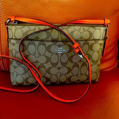 New Gift Never Used. Rich Classic Brown With Orange Strap 11’x 7’ Long Adjustable Strap. Orange Pouch Bag For On-the-go, Orange Travel Bag With Zipper Closure, Coach Orange Bag With Detachable Strap, Orange Crossbody Bag With Detachable Strap, Orange Bag With Adjustable Strap For Errands, Orange Shoulder Bag With Removable Pouch, Orange Zipper Closure Crossbody Shoulder Bag, Coach Orange Crossbody Shoulder Bag, Coach Orange Shoulder Bag