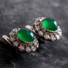 Emerald Victorian Studs set with Created Emerald in a cabochon cut & vivid green color, at size 10mm each together with Created CZ Diamonds at size 3mm each (10 Cts a pair). Solid 925 Sterling Silver ☞ made to last.Click here for ☞ Matching RingMatching Pendant ☞ please ask meClick here for ☞ Flower CollectionDetails:• Created Emerald in a vivid green color• Emerald: 10mm each, 8 Cts total, cabochon cut• CZ Diamonds: 3mm each, 2 Cts total, diamond cut• Lever Back Closure - "English Lock"• Dimens Elegant Green Gemstones For Formal Occasions, Green Gemstone Cabochons For Formal Use, Elegant White Gold Cabochons As Gift, Classic Green Clip-on Earrings, Elegant Round Emerald Earrings, Green Cabochons For Formal Fine Jewelry, Fine Jewelry Green Cabochons For Formal Occasions, Classic Green Round Earrings, Exquisite Round Cabochon Earrings