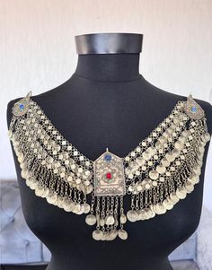 This is a unique antique Ottoman period fez necklace with Ottoman jewelry. It is a beautiful representation of Ottoman jewelry. The necklace is made of low-carat silver, and is an original piece made before 1920. Its originality makes it a valuable addition to any collection. , This necklace is perfect for those interested in Ottoman clothing and jewelry. You can use it in different designs The items I sell are not new, they are vintage or antique, of course it goes without saying that there may Ceremonial Medallion Jewelry With Historical Design, Bohemian Long Necklace For Ceremonial Occasions, Bohemian Long Necklace For Ceremonies, Antique Silver Necklace With Historical Design, Bohemian Heavy Ceremonial Jewelry, Traditional Medallion Jewelry With Historical Design, Traditional Pendant Necklace For Festivals, Antique Metal Necklaces For Festivals, Bohemian Metal Jewelry For Ceremonial Occasions