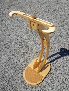 a wooden object sitting on top of a cement ground