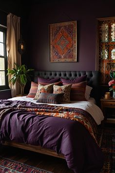 a bed in a bedroom with purple walls and pillows on it's headboard