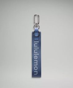 a blue lanyard with the words millennium on it and a metal hook attached to it